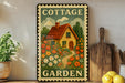 A vintage-style metal sign with a cottage garden illustration, placed on a wooden shelf next to a potted plant and kitchen utensils.