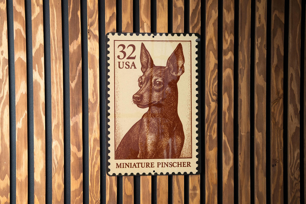 A brown and white miniature pinscher dog stamp is displayed on a wooden wall.