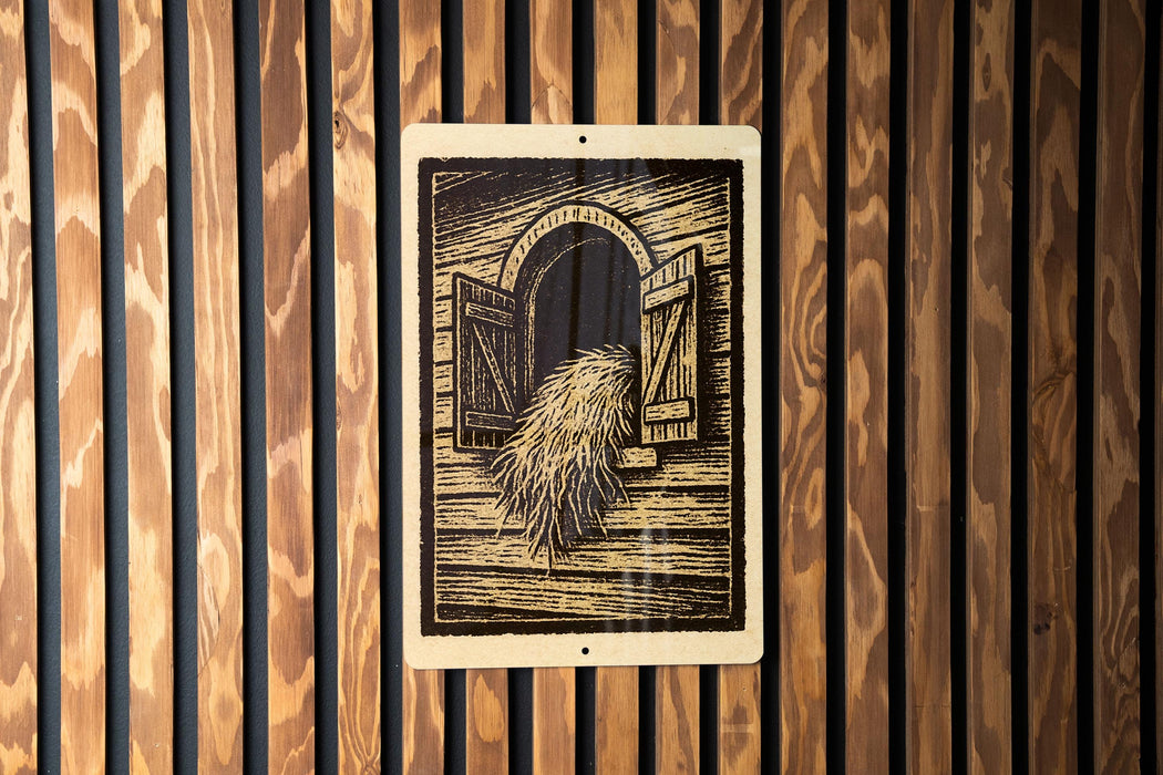 a wooden wall with a framed illustration of a horse's mane hanging on it.