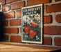 A vintage-style postage stamp featuring a strawberry patch, mounted on a brick wall.
