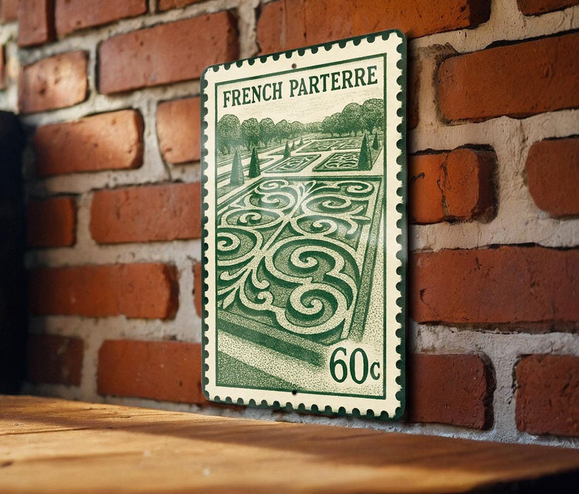 A French postage stamp featuring a garden scene is displayed on a brick wall.