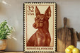 a vintage-style miniature postage stamp with a portrait of a dog, placed on a wooden surface next to a wooden cutting board and some lemons.