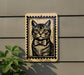 A framed image of a cat wearing a bow tie is displayed on a wall, with a plant visible to the left.