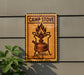 a sign with a picture of a camp stove on it, mounted on a wall.