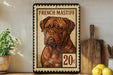 A French Mastiff dog is depicted on a postage stamp-like frame, with a wooden cutting board and lemons in the foreground.