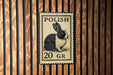 A metal sign with a rabbit illustration and the text "POLISH 20 GR" is displayed on a wooden wall.