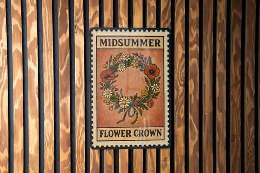 A vintage-style metal sign with the text "MIDSUMMER FLOWER CROWN" displayed on it, mounted on a wooden wall.