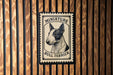 a bull terrier, a small and muscular breed of dog, with a stamp-like design on a wooden background.