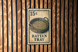 A metal sign with a wicker basket on it, mounted on a wooden wall.