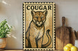 a cougar, a large mountain cat, on a wooden surface.