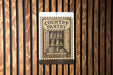 a sign for a country pantry, with a wooden background and a pantry door illustration.