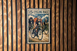 A vintage-style poster of three cyclists racing, with the text "15c cycling race" prominently displayed.