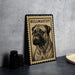 A metal sign with a bull mastiff illustration on it, placed on a countertop next to some black camera lenses.