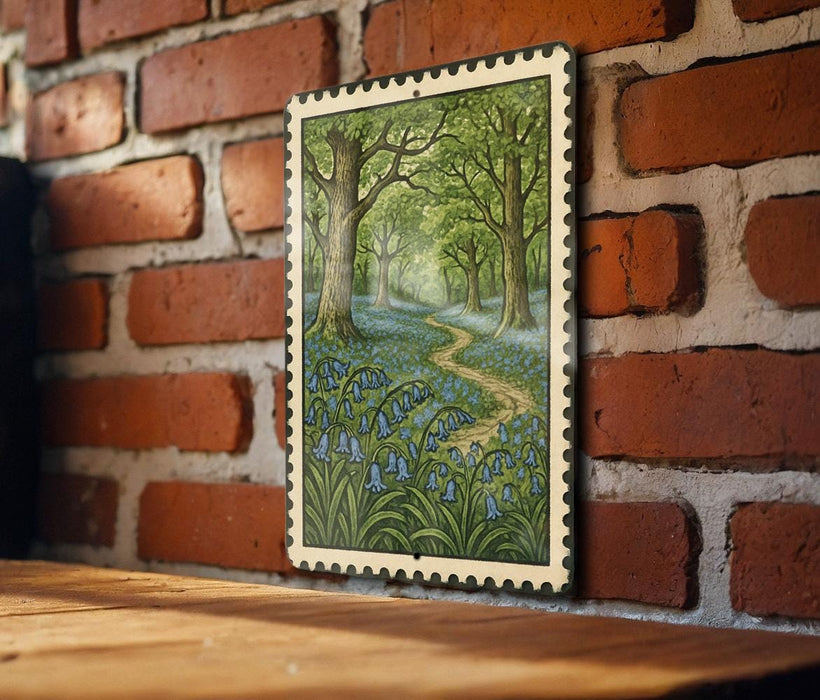 A framed painting depicting a lush forest scene with a winding path through the trees and bluebells growing in the foreground.