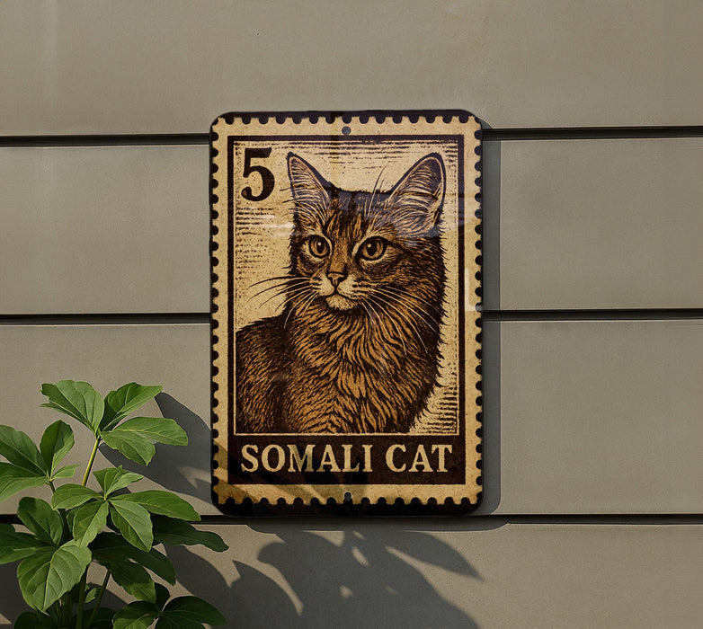 A wooden sign featuring a cat image, mounted on a wall next to a plant.
