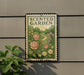 a sign that reads "Scented Garden" with a floral illustration of roses, daisies, and other flowers. The sign is mounted on a wall, and there is a plant to the left of the sign.