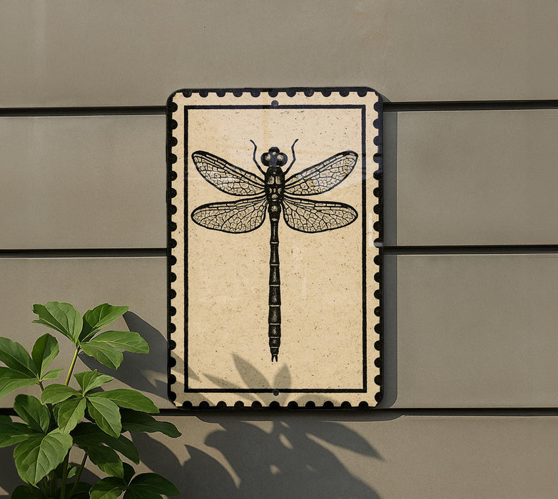 a decorative tile with a detailed illustration of a dragonfly on it, mounted on a wall.