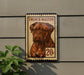A French mastiff dog is depicted on a postage stamp-like sign, mounted on a wall.