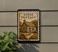 a sign that reads "STONE COTTAGE" with a small illustration of a cottage on it, mounted on a wall.