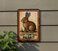A sign featuring a picture of a cottontail rabbit, with the text "COTTONT tail RABBIT" displayed on it.