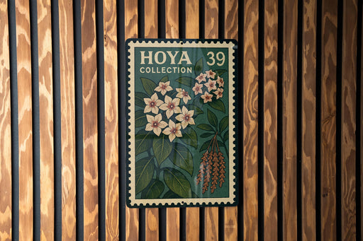 A vintage-style stamp with floral designs and text, mounted on a wooden wall.