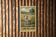 A vintage-style stamp depicting a lamb standing in a grassy field, with the text "LAMB MEADOW" below the image.