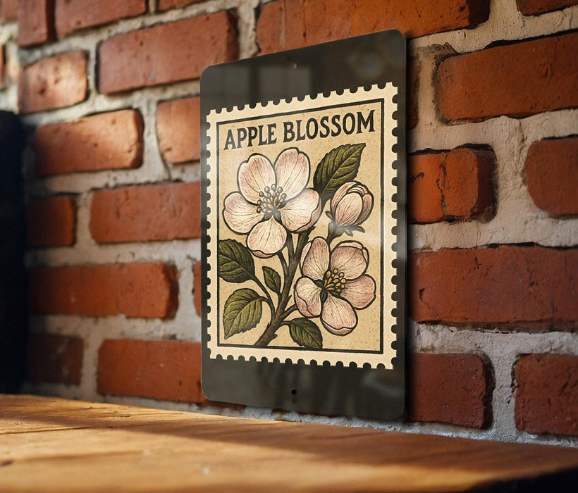 a brick wall with a framed illustration of an apple blossom on it.