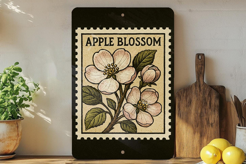 a framed illustration of an apple blossom on a shelf, with a wooden cutting board and a potted plant to the left.