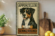 A metal sign featuring a picture of an Appenzeller dog, with the text "Appenzeller" and "Sennenzund" printed on it. The sign is displayed on a shelf next to a wooden cutting board and some potted plants.