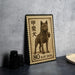 A stamp featuring a dog, specifically a kai dog, which is a breed of dog native to Japan. The stamp has a black and brown color scheme and is placed on a gray surface.