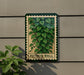 A green and white sign with a plant illustration is mounted on a wall, with a plant visible to the left side of the sign.