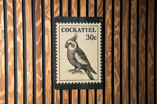 A black and white postage stamp featuring a detailed illustration of a cockatoo, with the text "COCKATIEL 30c" printed on it.