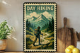 a vintage-style metal sign with a hiker walking on a trail through a mountainous landscape, surrounded by pine trees and a cloudy sky.