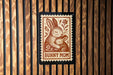 A brown and white stamp-like design featuring a mother rabbit and her baby, with the text "BUNNY MOM" below the illustration.