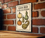 A sign for a gourd collection is displayed on a brick wall, featuring illustrations of various gourds.