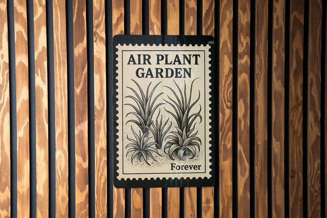 a sign that reads "Air Plant Garden Forever" with a black and white illustration of a plant on it, mounted on a wooden wall.