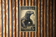 A black and white stamp featuring a Komodo dragon, with the text "KOMODO DRAGON" and the value "5c" printed on it.