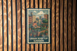 A vintage-style metal sign with a woman tending to a garden, mounted on a wooden wall.