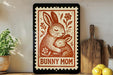 A framed image of a mother rabbit and her baby rabbit, with the text "BUNNY MOM" on the frame.