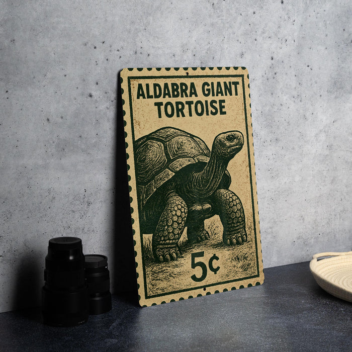 A vintage postage stamp featuring an illustration of a giant tortoise, with the text "ALDABRA GIANT TORTOISE" and the denomination "5c".