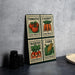 A wooden board displaying four postage stamps with illustrations of tomatoes, carrots, radishes, and corn seeds, along with the words "Seed Packet" printed on them.