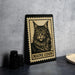 A framed image of a Maine Coon cat is displayed on a wall, with a black and white stamp-like border.