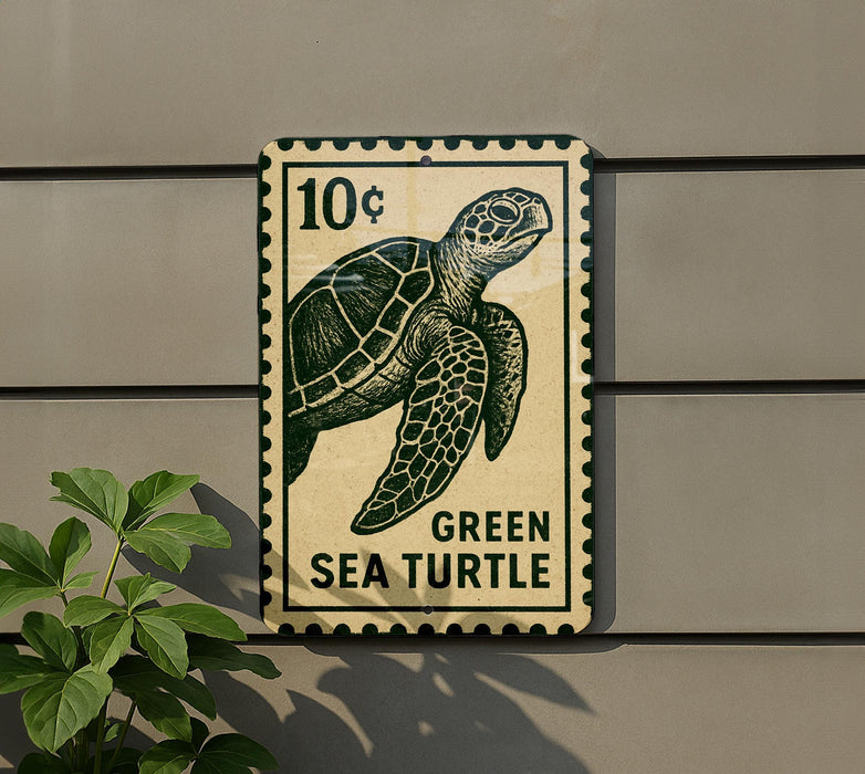 A green sea turtle stamp is attached to a wall, with a plant visible to the left.