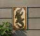 a decorative sign with an illustration of a crocodile, which is mounted on a wall.