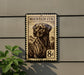 a dog, specifically a mountain dog, depicted on a postage stamp-like sign mounted on a wall.