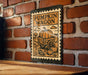 A wooden table with a pumpkin-themed sign hanging on a brick wall.