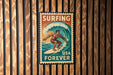 A vintage-style metal sign with the text "Surfing USA Forever" and an illustration of a surfer riding a wave.