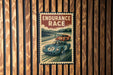 A vintage-style poster with the text "ENDURANCE RACE" and an illustration of two race cars on a track.