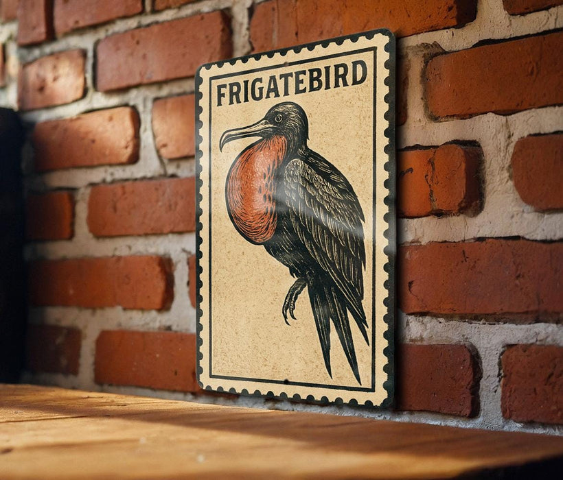 a wooden table with a framed illustration of a Frigatebird on it, mounted on a brick wall.