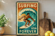 A vintage-style metal sign with the text "SURFING USA FOREVER" and an illustration of a surfer riding a wave.